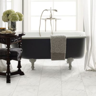 marble tile flooring in a bright bathroom with a tub